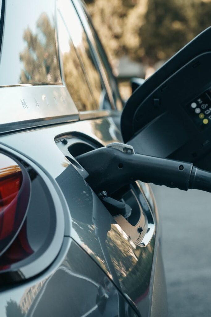 pexels-photo-9800009-9800009 Close-up of an electric vehicle being charged, highlighting modern clean energy technology.